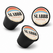 Three SLABBB Coffee capsules on a white background